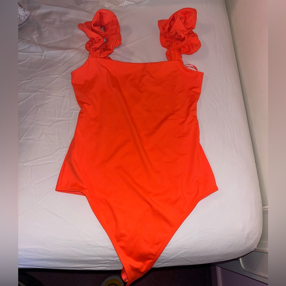 Neon orange bodysuit. Size small. New with tags. Never worn!